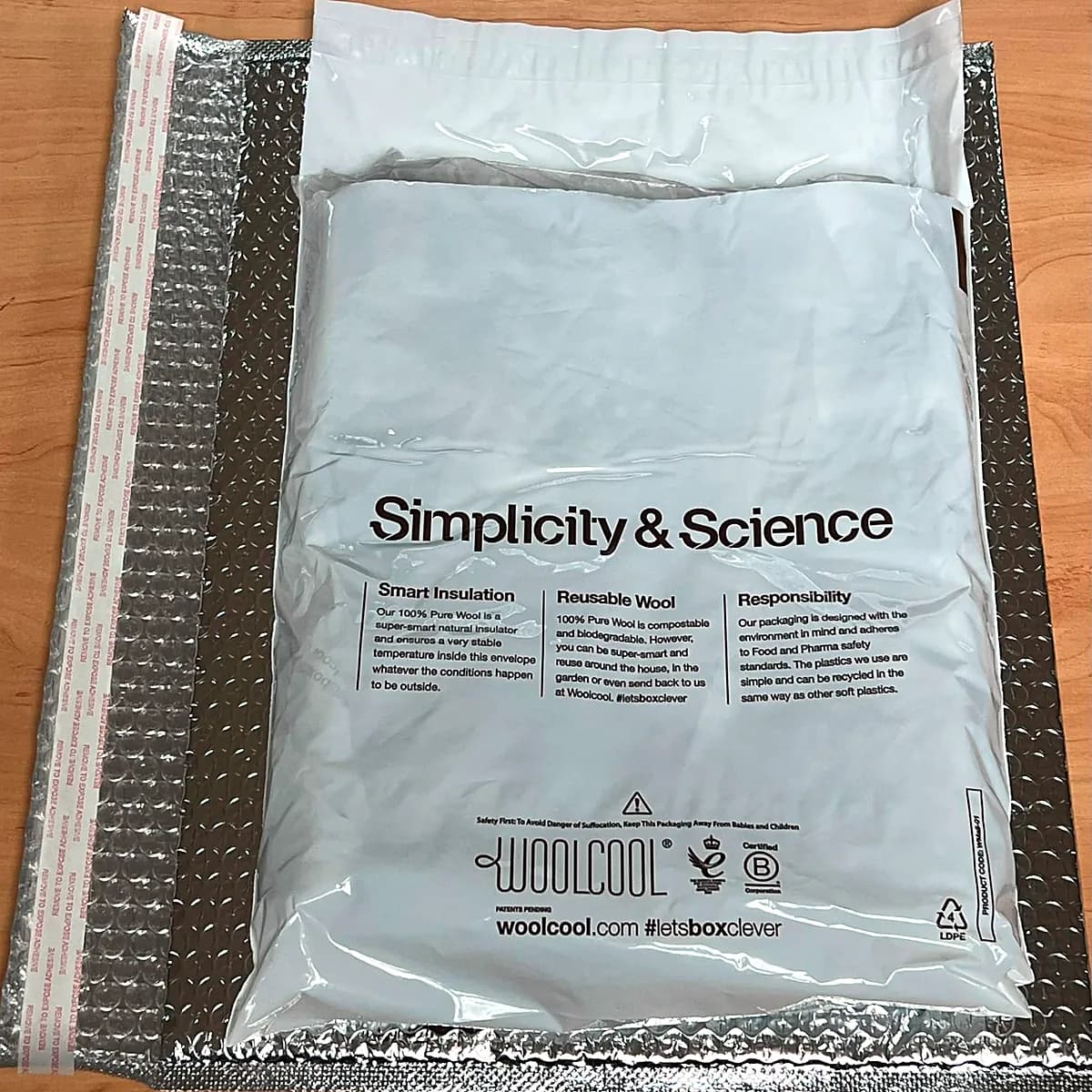 The sealed wool envelope inside a foil-lined thermal mailer.